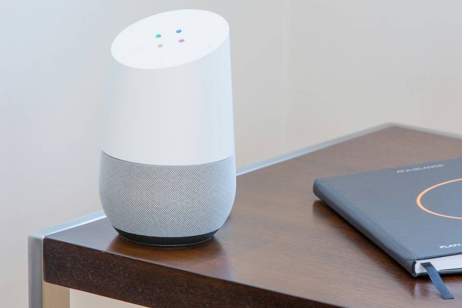Modern smart home living room with automated lighting and voice assistant hub